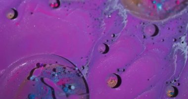 Ink splash. Bubbles background. Defocused purple pink blue color bright water round oil texture flowing on art vibrant abstraction.