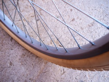 Beton zeminde duran beyaz lastikli klasik bisiklet tekerleği..