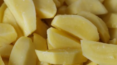 Patates dilimleri baharatlı ve pişirilmeye hazır.