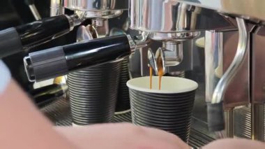 Barista profesyonel espresso makinesi kullanarak hazır kahve hazırlıyor.
