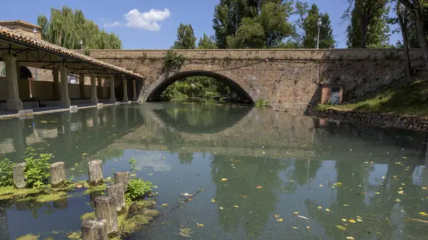Nehrin güzel manzarası ve Bevagna, Umbria, İtalya 'nın tarihi merkezindeki küçük köprüsü..