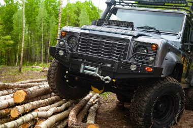 Equipped Land Rover Defender in the forest, ready for off road clipart