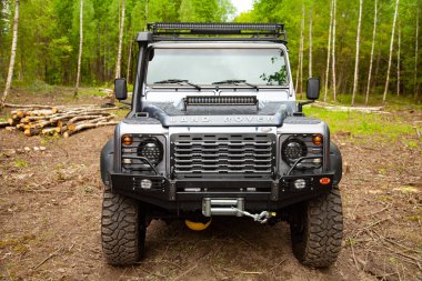 Equipped Land Rover Defender in the forest, ready for off road clipart