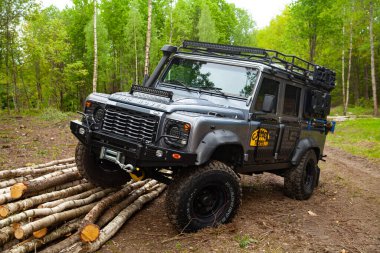 Ormandaki donanımlı Land Rover Koruyucusu, off road için hazır, yeteneklerini gösteriyor.