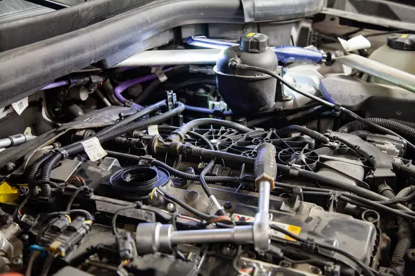 View of the engine without a cover under the hood of a car