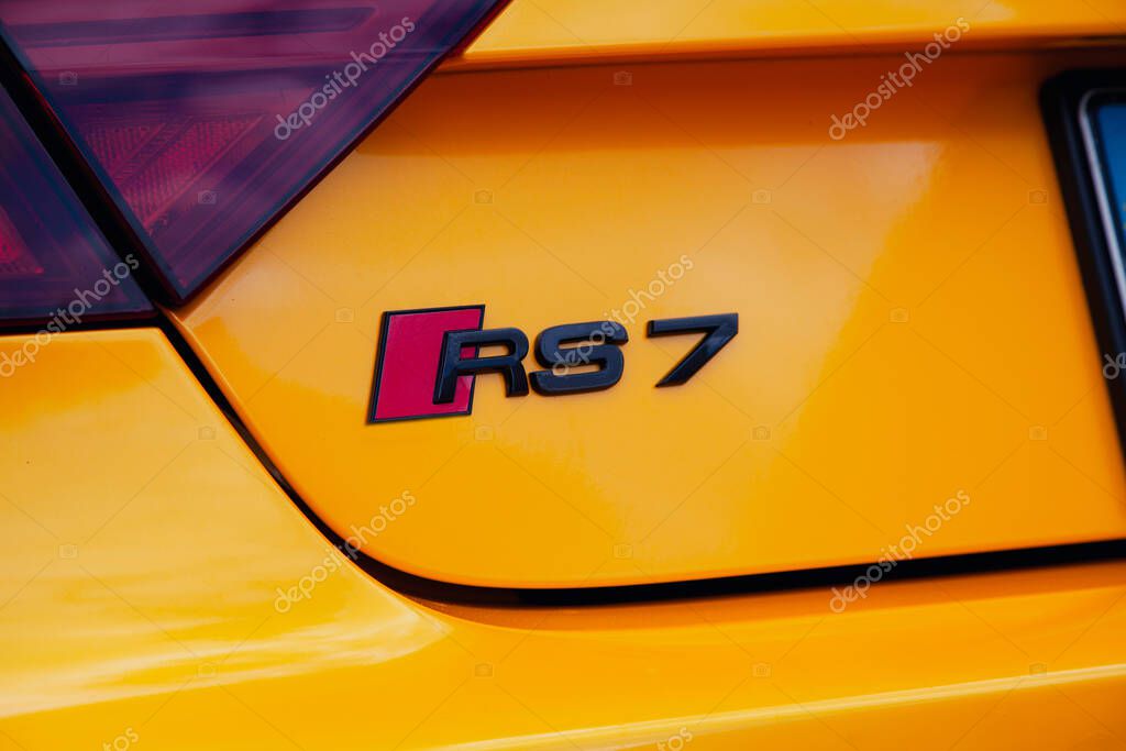 Vilnius, Lithuania - 31-05-2025 - Close-up of the RS7 emblem on the rear of a mustard-colored Audi sports car