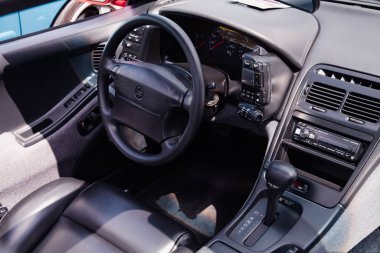 Vilnius, Lithuania - 31-05-2025 - Close-up interior shot of a Nissan 300ZX Targa with distinctive Z-logo steering wheel, showcasing vintage Japanese sports car design
