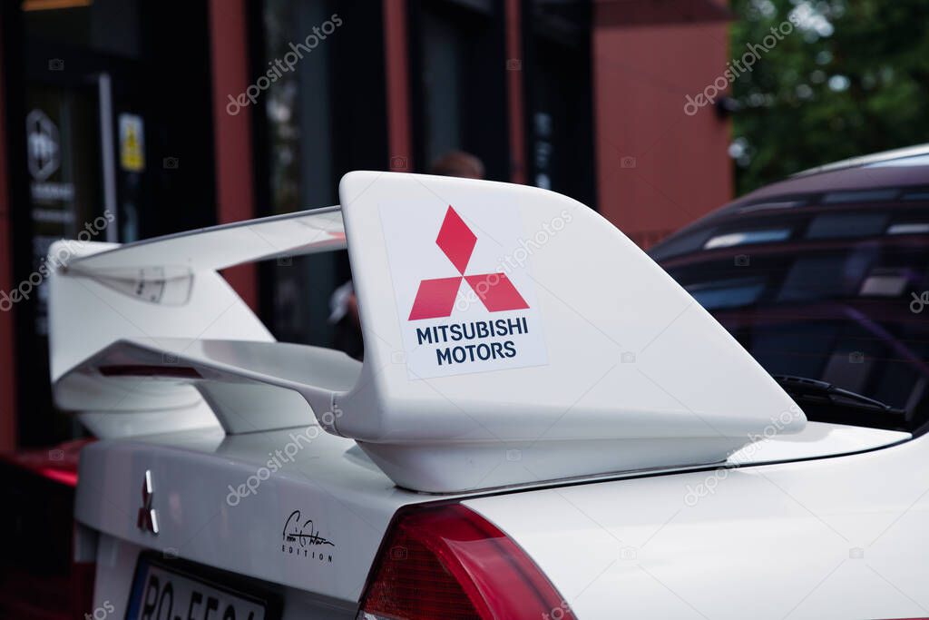 Vilnius, Lithuania - 31-05-2025 - Close-up of the Mitsubishi Motorsport emblem on the trunk spoiler of a pristine white Mitsubishi, emphasizing performance branding and rear design elements