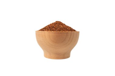 Rooibos tea medium cut in wooden bowl isolated on white background. Rooibos in latin Aspalathus linearis. herb. herbal tea. food ingredient.