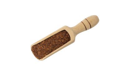 Rooibos tea medium cut in wooden scoop isolated on white background. Rooibos in latin Aspalathus linearis. herb. herbal tea. food ingredient.