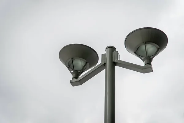 Black street lamp, lamppost, streetlight; with white sky background