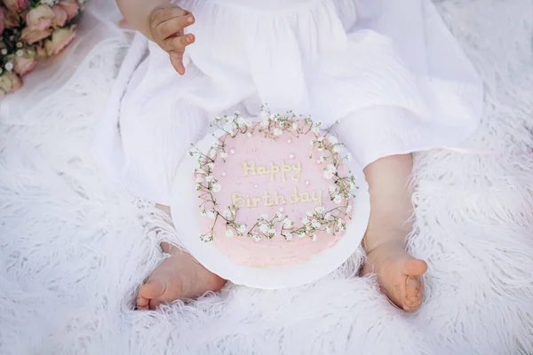 Baby birthday cake and newborn feet, toes, very pretty and sweet. First birthday smash the cake