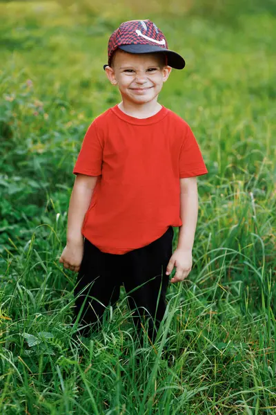 Gün batımında kameraya bakan küçük çocuk portresi. Hırslı gençler. Genç nesil. Gün batımında poz veren komik çocuk eğlenceli ve olumlu duygular besliyor. Yaşam biçimi