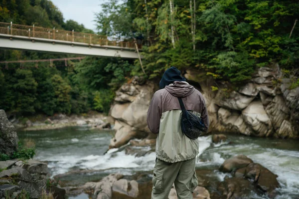 Чоловічий Турист Повсякденному Одязі Стоїть Скелі Біля Гірської Річки Тлі — стокове фото