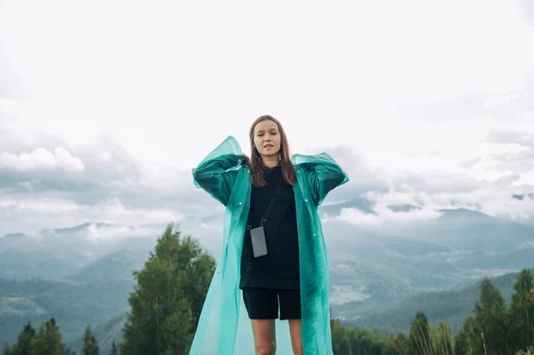 Portrait Female Tourist Raincoat Stands Mountains Background Overcast Views Poses Stok Foto Bebas Royalti