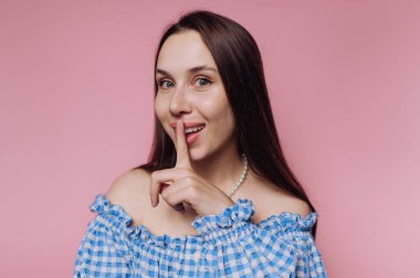 Mavi omuzlu kadın şşşş hareketi yapıyor..