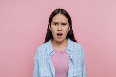 Pembe arka plana karşı şaşırmış genç bir kadın..