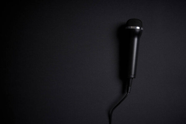 Black microphone on black background