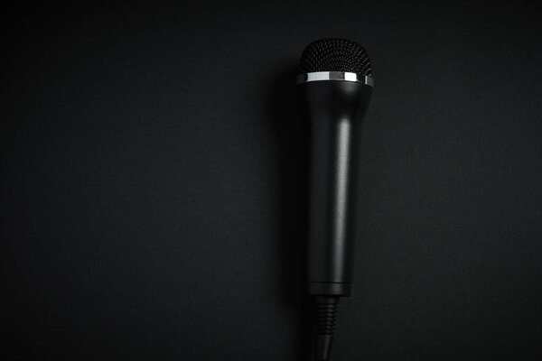 Black microphone on black background