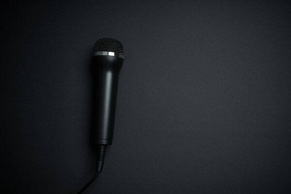 Black microphone on black background