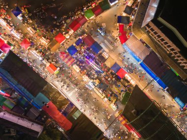 Gece tapınağındaki eğlence parkının hava manzarası ve gece pazarları. İnsanlar Bangkok, Tayland 'da renkli çadırlarda yürüyor. Perakende mağazaları