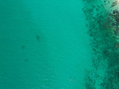 Açık mavi turkuaz deniz suyu olan teknelerin havadan görünüşü, Tayland 'da yaz mevsiminde Phuket Adası' ndaki Andaman denizi. Okyanus materyali desenli duvar kağıdı arka planında su.