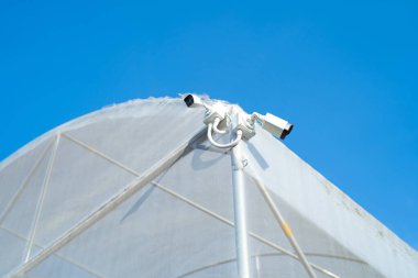 CCTV security camera or closed circuit television at building exit way at farm. Digital safety and motion recorder. Video surveillance. Technology monitor.