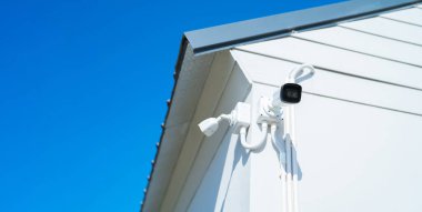 CCTV security camera or closed circuit television at building exit way at home or house. Digital safety and motion recorder. Video surveillance. Technology monitor.