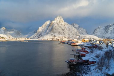 White snow mountain in Lofoten islands, Nordland county, Norway, Europe. Hills and trees, nature landscape in winter season. Winter background.