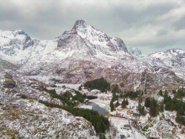 White snow mountain in Lofoten islands, Nordland county, Norway, Europe. Hills and trees, nature landscape in winter season. Winter background.