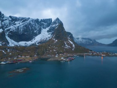 White snow mountain in Lofoten islands, Nordland county, Norway, Europe. Hills and trees, nature landscape in winter season. Winter background.