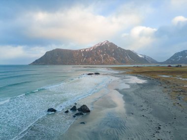 White snow mountain in Lofoten islands, Nordland county, Norway, Europe. Hills and trees, nature landscape in winter season. Winter background.