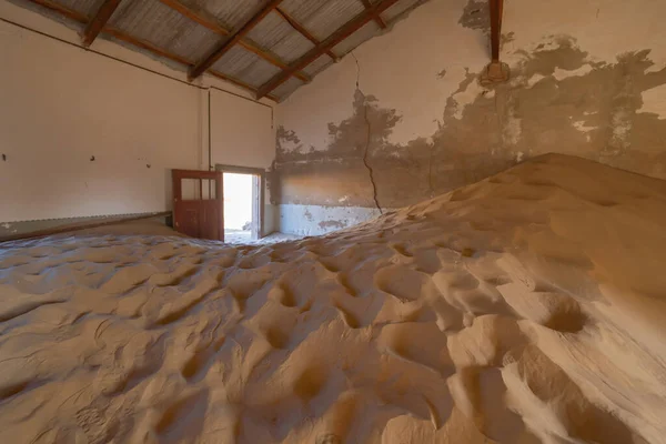 stock image Kolmanskop, The abandoned houses. the famous tourist attraction in Namibia, South Africa. Empty sand dune in home room . The ghost town.