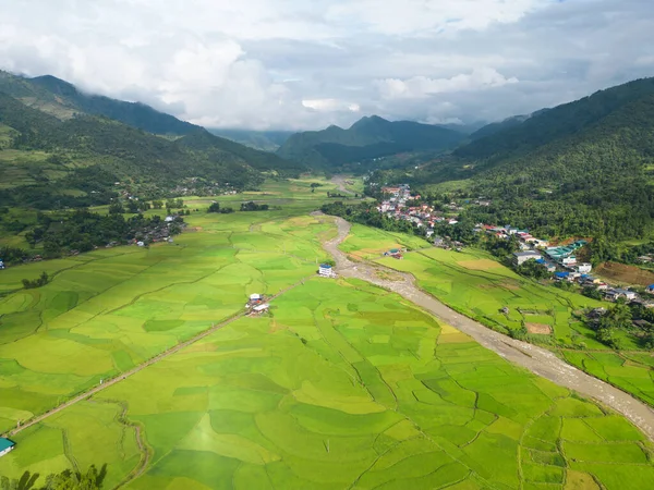 stock image Aerial top view of fresh paddy rice terraces, green agricultural fields in countryside or rural area of Mu Cang Chai, mountain hills valley in Asia, Vietnam. Nature landscape background.