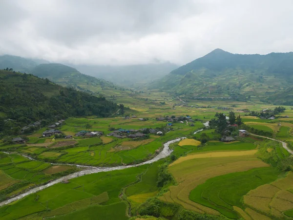 stock image Aerial top view of fresh paddy rice terraces, green agricultural fields in countryside or rural area of Mu Cang Chai, mountain hills valley in Asia, Vietnam. Nature landscape background.