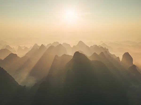 stock image Aerial top view of forest trees and green mountain hills with fog, mist and clouds. Nature landscape background, Vietnam.