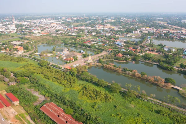 Aerial top view of a garden park with green forest trees, river, pond or lake. Nature landscape background, Thailand.