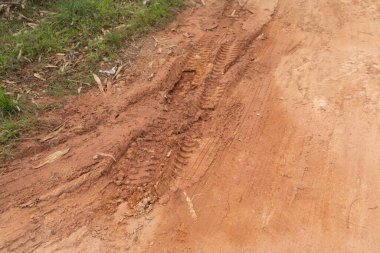 Çamurlu araba tekerleği, kırmızı toprak yüzey yolu. Yolculukta macera. Çamur.