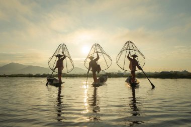 Birmanyalı balıkçılar, Myanmar 'da Asya' nın doğal nehri olan Unle Gölü 'nde tatlı su balığı yakalamak için ağ atıyor ya da atıyorlar. İnsan yaşam tarzı.
