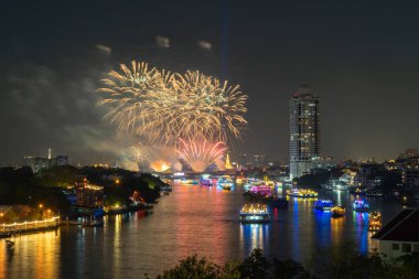 Fireworks at Memorial Bridge, and Phra Pok Klao Bridge with buildings and Chao Phraya River at night. Urban city, Downtown Bangkok, Thailand. clipart