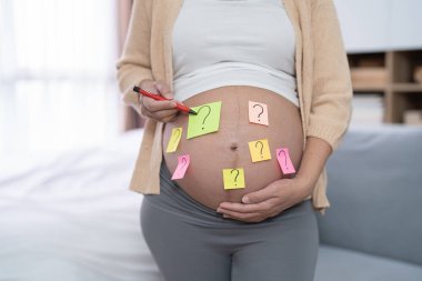 Boş seks notu olan mutlu Asyalı hamile bir kadının portresi. Bebek sahibi olmak. Aile hayatı işte. Annen seni seviyor.