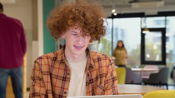 Молодой Программист Сидящий Столом Кафе Работающий Ноутбуке Носит Желтую Рубашку — стоковое видео