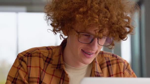 Hombre Pelirrojo Enfocado Gafas Usando Portátil Sentado Oficina Adolescente Freelancer — Vídeo de stock
