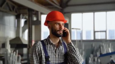 Büyük bir metal fabrikasında miğfer takan genç bir işçi telefonda konuşuyor. Bitmiş ürün deposunda çalışan profesyonel bir işçi sipariş veriyor..