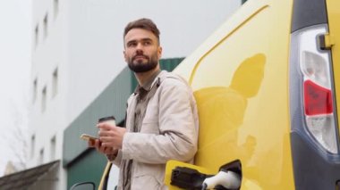 Teslimatçı depoya yakın bir yerde kargo elektrikli araba yüklüyor.