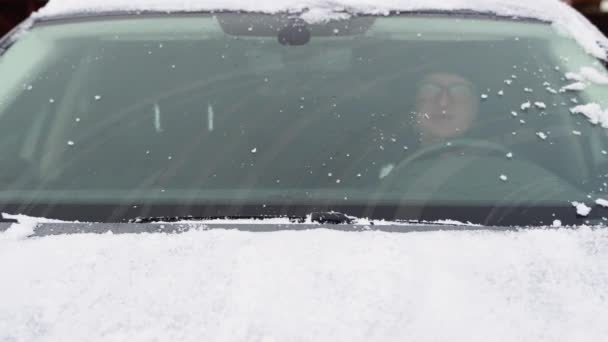 Young Man Cleaning Snow Car Windshield Outdoors Winter Day — Stock Video