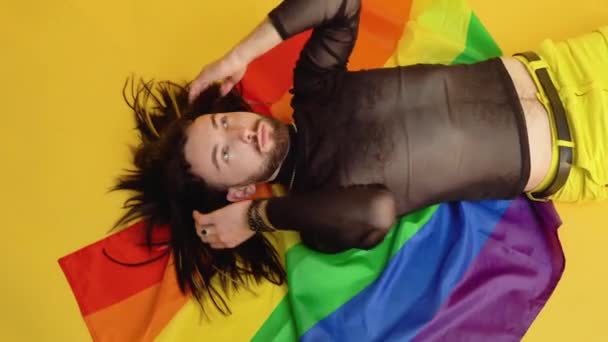 Gay Man Dressed Mesh Shirt Lies Yellow Background Multicolored Rainbow — Stock Video