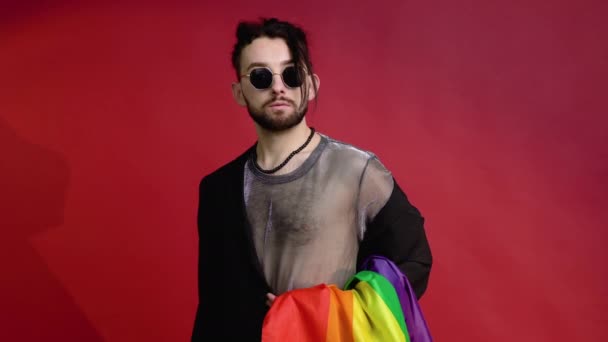 Gay Man Dressed Mesh Shirt Sunglasses Sits Red Background Multicolored — Stock Video
