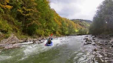 Young person rafting on the river Ganges in Rishikesh, extreme and fun sport at tourist attraction
