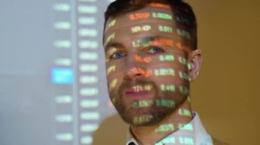 Confident professional businessman looking in camera with stock trade or cryptocurrency graph in background